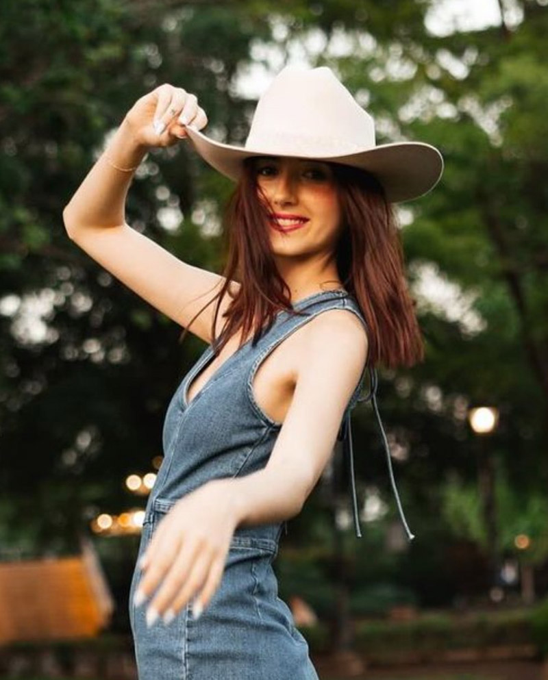 Haley Bundy posing with a cowboy hat.